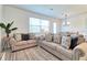 Comfortable living room with plush sofas, decorative pillows, and view of the dining area at 832 Longboat Dr, Davenport, FL 33896
