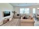 Cozy living room with comfortable seating, stylish decor, and ample natural light at 832 Longboat Dr, Davenport, FL 33896