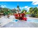Community splash pad with a whimsical pirate ship and various water features for children at 832 Longboat Dr, Davenport, FL 33896