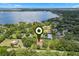 Breathtaking aerial view of a lakeside community featuring lush greenery and a range of stunning residential properties at 9601 Ambleside Dr, Windermere, FL 34786