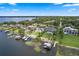 Stunning aerial view of lakefront homes, docks, and lush landscaping, showcasing a desirable waterfront community at 9601 Ambleside Dr, Windermere, FL 34786