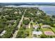 Scenic aerial view showcasing a neighborhood with tree-lined streets and a glimpse of a beautiful lake in the background at 9601 Ambleside Dr, Windermere, FL 34786