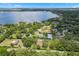 Breathtaking aerial view of a lakeside community featuring lush greenery and a range of stunning residential properties at 9601 Ambleside Dr, Windermere, FL 34786