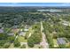 High angle view of the neighborhood with mature trees and well-maintained lawns. This image shows a basketball and tennis court at 9601 Ambleside Dr, Windermere, FL 34786