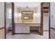 A well-lit bathroom vanity includes unique pendant lighting and custom cabinets at 9601 Ambleside Dr, Windermere, FL 34786