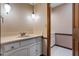 Bathroom vanity with marble countertop and decorative wall mirror with lighting at 9601 Ambleside Dr, Windermere, FL 34786