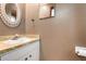 Bathroom sink with rounded vanity and mirror on tan colored walls at 9601 Ambleside Dr, Windermere, FL 34786