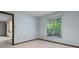 A small bedroom contains beige carpeted floors and a single window at 9601 Ambleside Dr, Windermere, FL 34786