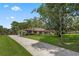 Lovely home with a long driveway, lush lawn, and mature landscaping creates inviting curb appeal at 9601 Ambleside Dr, Windermere, FL 34786