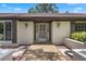 Inviting home front entrance features stylish lighting, enhancing the curb appeal and welcome ambiance at 9601 Ambleside Dr, Windermere, FL 34786
