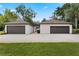 Spacious two-car garages providing ample parking and storage space, set against a lush lawn at 9601 Ambleside Dr, Windermere, FL 34786