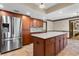 Spacious kitchen features stainless refrigerator, center island and ample cabinets at 9601 Ambleside Dr, Windermere, FL 34786