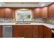 A bright kitchen showcases stainless appliances and natural stone backsplash at 9601 Ambleside Dr, Windermere, FL 34786