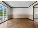 Inviting living room boasting hardwood floors, ample natural light, and easy access to an outdoor patio at 9601 Ambleside Dr, Windermere, FL 34786
