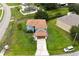 Bright blue, two-story home with a brown roof, long driveway and lots of lawn space at 1001 Dampierre Ct, Kissimmee, FL 34759