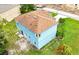 Two-story blue home with brown shingle roof, green lawn, with construction work nearby at 1001 Dampierre Ct, Kissimmee, FL 34759