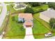 An aerial view of a two-story, blue home with a red property line and large lawn at 1001 Dampierre Ct, Kissimmee, FL 34759