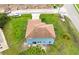 Two-story blue house with brown shingle roof, large backyard with construction nearby at 1001 Dampierre Ct, Kissimmee, FL 34759