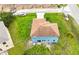 Aerial view of two-story blue house with brown shingle roof and large backyard at 1001 Dampierre Ct, Kissimmee, FL 34759
