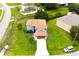Aerial view of a two-story, blue home with a large front lawn and two-car garage at 1001 Dampierre Ct, Kissimmee, FL 34759