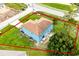 An aerial view of a two-story, blue home with a red property line and large lawn at 1001 Dampierre Ct, Kissimmee, FL 34759