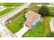 An aerial view of a two-story, blue home with a red property line and large lawn at 1001 Dampierre Ct, Kissimmee, FL 34759