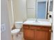 A full bathroom with a single sink and toilet features a wooden vanity for storage at 1001 Dampierre Ct, Kissimmee, FL 34759