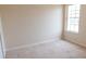 This bedroom features neutral walls and a window for natural light at 1001 Dampierre Ct, Kissimmee, FL 34759