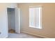Bedroom with neutral walls and carpeting, a window with blinds and a closet to the side at 1001 Dampierre Ct, Kissimmee, FL 34759