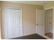 Bedroom area featuring white doors, and carpeted flooring at 1001 Dampierre Ct, Kissimmee, FL 34759