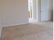 Bedroom with neutral walls and carpeting, an attached bathroom, and a closet to the left at 1001 Dampierre Ct, Kissimmee, FL 34759