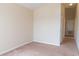 A compact bedroom with neutral carpeting and walls features a closet off to the side at 1001 Dampierre Ct, Kissimmee, FL 34759