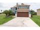 Two-story home with two-car garage and neutral exterior at 1001 Dampierre Ct, Kissimmee, FL 34759