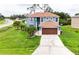 Two-story home with a large front yard, driveway, and two-car garage at 1001 Dampierre Ct, Kissimmee, FL 34759