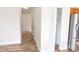 Hallway view featuring wood-look flooring, white walls, and storage at 1001 Dampierre Ct, Kissimmee, FL 34759