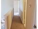 Hallway with neutral walls leads to a bedroom; a thermostat is attached to the right wall at 1001 Dampierre Ct, Kissimmee, FL 34759