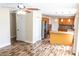 Spacious open-plan kitchen with stainless steel refrigerator, wood-look floors, and modern fixtures at 1001 Dampierre Ct, Kissimmee, FL 34759