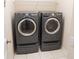 A utility room showcasing a gray washer and dryer with tile floors at 1001 Dampierre Ct, Kissimmee, FL 34759