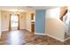 Open-concept living room featuring wood-look floors and natural light at 1001 Dampierre Ct, Kissimmee, FL 34759