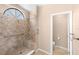 Bathroom with tiled walk-in shower featuring a window, bench, and accessible grab bar at 1003 Jackson Creek Ct, Oviedo, FL 32765
