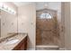 Bathroom with granite vanity, large mirror, and tiled walk-in shower with a bench at 1003 Jackson Creek Ct, Oviedo, FL 32765