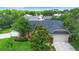 Beautifully landscaped front yard of home with mature trees and manicured lawn at 1003 Jackson Creek Ct, Oviedo, FL 32765