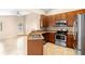 Open kitchen with stainless steel appliances, granite counters, breakfast bar, and ample cabinet space at 1003 Jackson Creek Ct, Oviedo, FL 32765