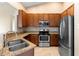 Well-equipped kitchen with stainless steel appliances, granite counters, tile backsplash and ample storage at 1003 Jackson Creek Ct, Oviedo, FL 32765