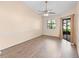 Bright living room featuring wood floors, a ceiling fan, and sliding doors to the outside at 1003 Jackson Creek Ct, Oviedo, FL 32765