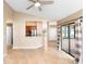 Large open living area with view to the kitchen area and glass doors to the exterior at 1003 Jackson Creek Ct, Oviedo, FL 32765