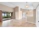 Airy living room with tile floors, neutral walls, and a sliding glass door to the porch at 1003 Jackson Creek Ct, Oviedo, FL 32765
