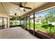 Relaxing screened-in patio with ceiling fans overlooks the lush green backyard at 1003 Jackson Creek Ct, Oviedo, FL 32765