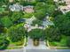 A gated community entrance is marked with mature trees and landscaping in this aerial view at 11015 Hawkshead Ct, Windermere, FL 34786