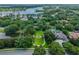Aerial view of a beautiful estate with lush landscaping, pool, and lake views at 11015 Hawkshead Ct, Windermere, FL 34786